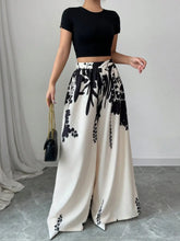 White wide leg pants with black floral print – front view