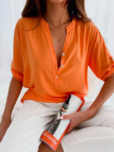 Front view of Casual chic orange blouse paired with white trousers – Voguelle