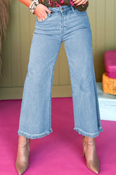 Front view of light blue high waist wide leg jeans with frayed hem – Voguelle