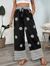 Front view of black boho print wide leg pants with white border – Voguelle