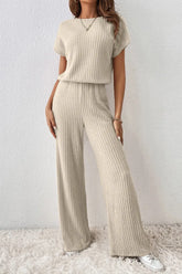 Front view of Ribbed Knit Wide Leg Jumpsuit in beige on model – Voguelle