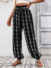 Front view of black printed wide leg pants on model – Voguelle