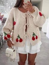 Front view of beige cherry pattern tie-front oversized cardigan on model – Voguelle