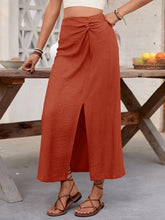 Front view of rust sheath midi skirt with side slit on model – Voguelle
