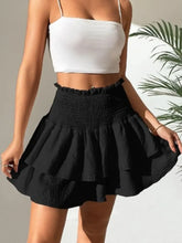 Front view of High Waist Smocked Layered Mini Skirt in black on model – Voguelle
