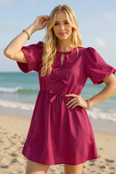 Front view of Oh Bow Ruched Puff Sleeve Mini Dress in magenta on model – Voguelle