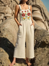 Front view of floral embroidered wide-leg jumpsuit in beige on model – Voguelle