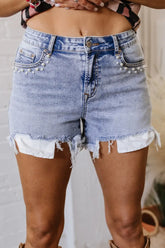 Front view of women’s pearl studded raw hem denim shorts – Voguelle