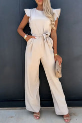 Front view of Round Neck Cap Sleeve Jumpsuit in beige on model – Voguelle