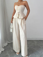 Model in beige tube top and wide-leg trousers – Voguelle