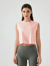 Front view of cropped round neck peach tank top on model – Voguelle