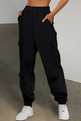 Front view of black pocketed elastic waist joggers on model – Voguelle