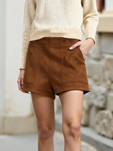 Front view of brown pocketed casual shorts on model – Voguelle