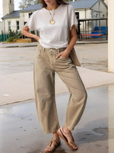 Front view of relaxed fit wide leg jeans in beige on model – Voguelle