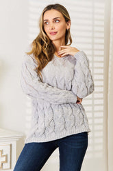Front view of Woven Right Cable-Knit Hooded Sweater in light grey on model – Voguelle