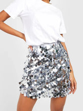 Front view of silver shimmery sequin mini skirt on model – Voguelle