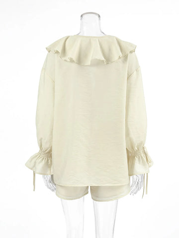 Front detail of ruffle neckline on cream long sleeve blouse – Voguelle