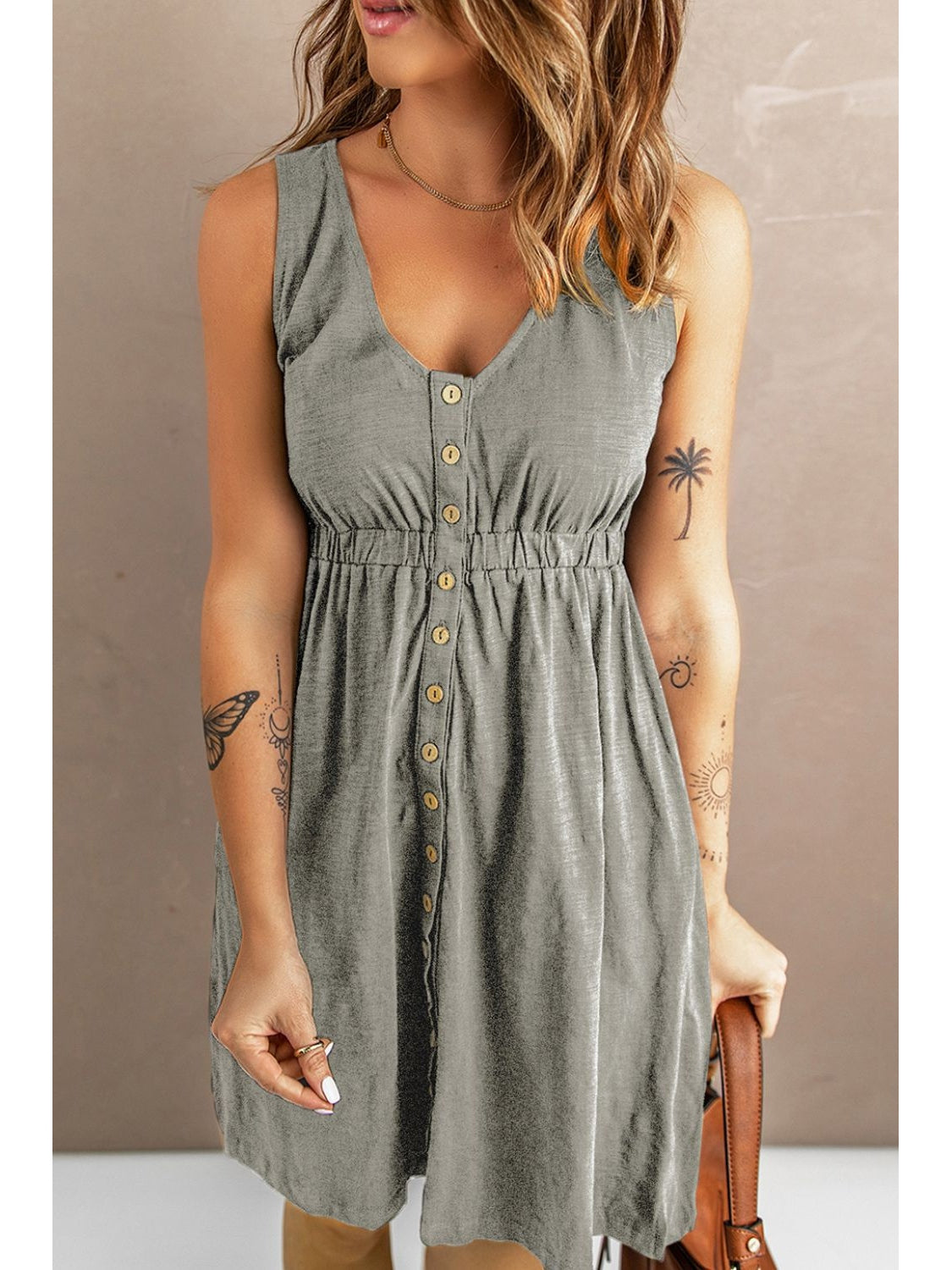 Model styling handbag with sleeveless button down dress – Voguelle
