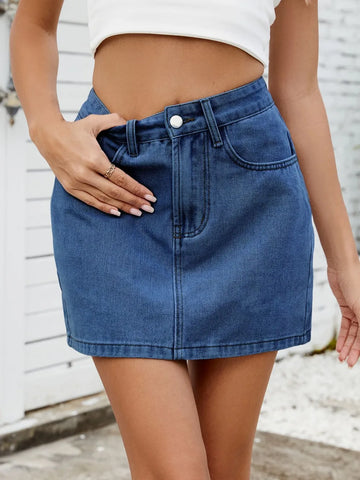 Front view of solid mini denim skirt in medium blue on model – Voguelle