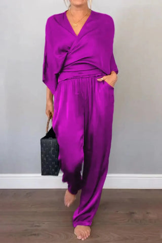 Surplice V-neck black jumpsuit with side pockets – Voguelle