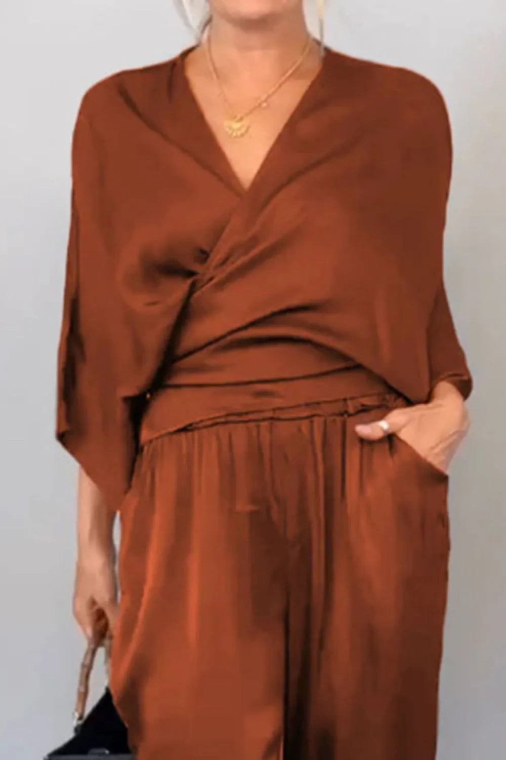 Surplice neckline black jumpsuit with relaxed silhouette – Voguelle