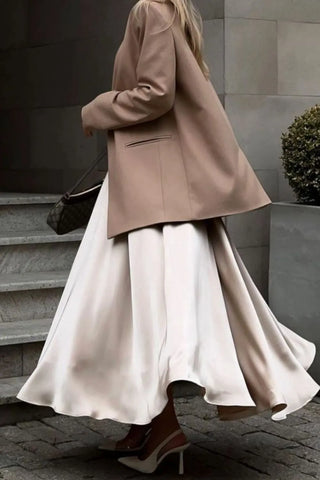 Model walking in champagne satin midi skirt and blazer, showing skirt movement – Voguelle