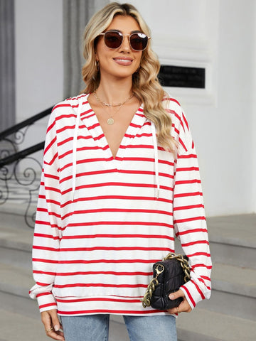 Model posing in lightweight striped hoodie – Voguelle