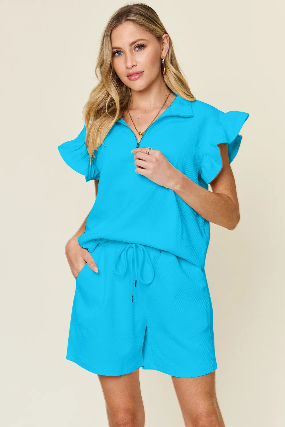 Model wearing chic cream co-ord with drawstring shorts – Voguelle
