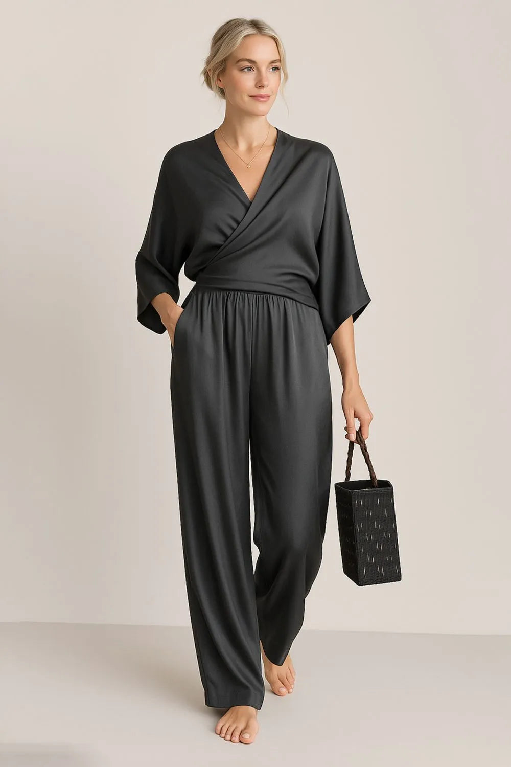 Black wrap-style surplice jumpsuit with pockets – Voguelle