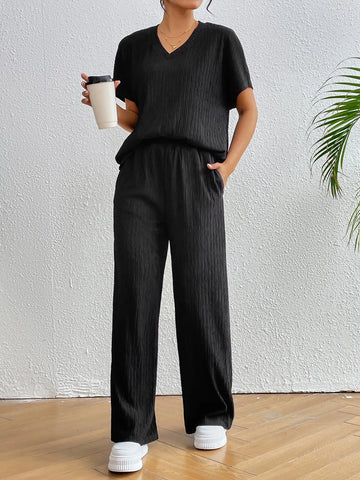 Side angle of black two-piece outfit with relaxed fit pants – Voguelle