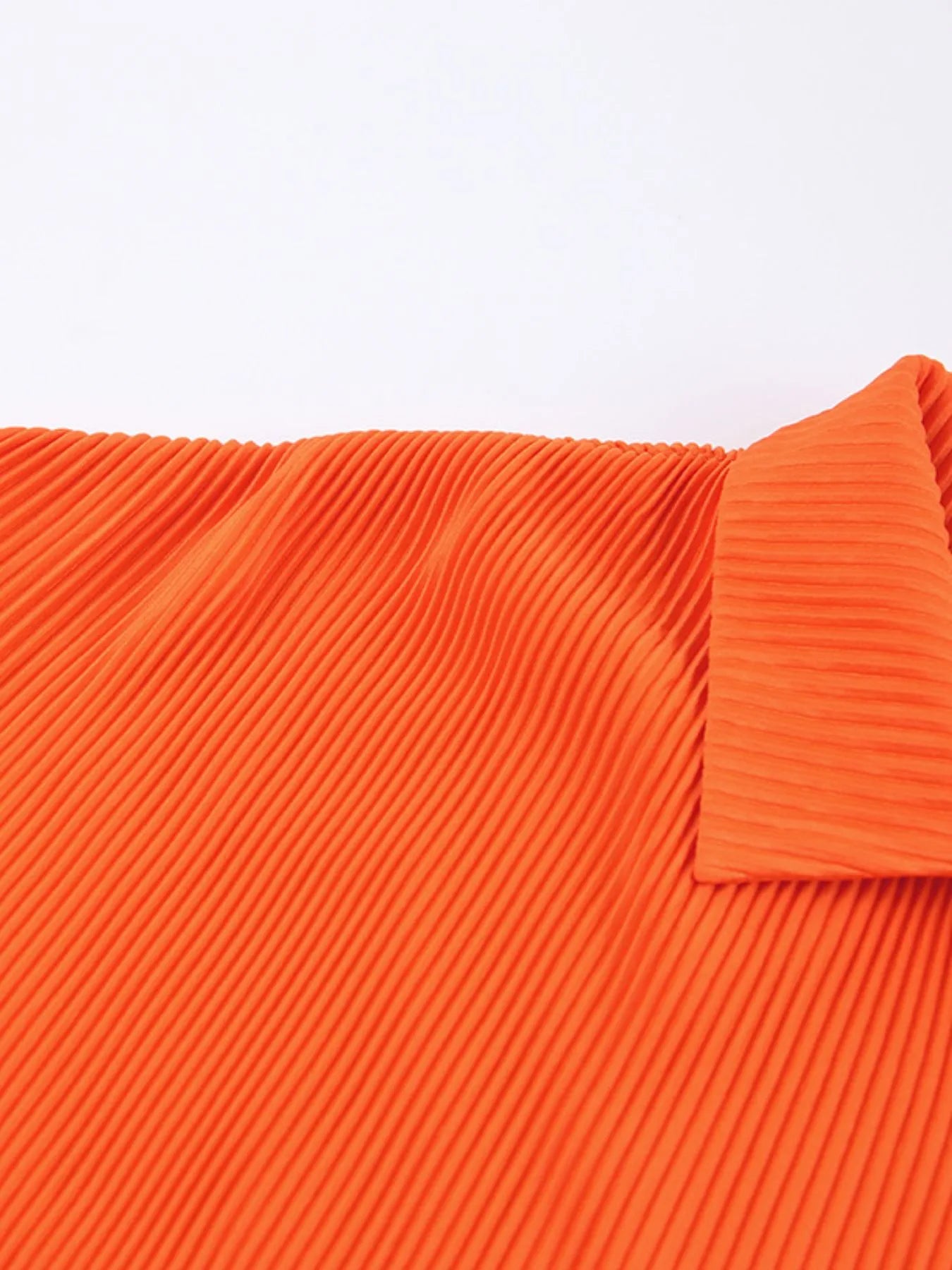 Model showcasing chic button-up shirt in orange set – Voguelle
