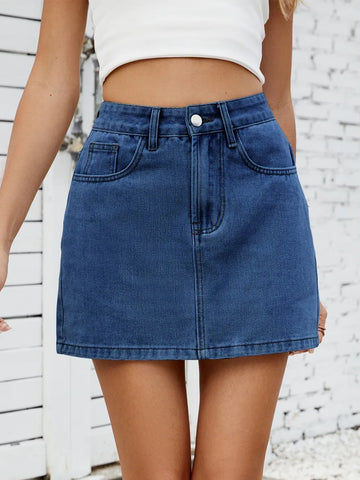 Model wearing solid mini denim skirt with white top, full outfit view – Voguelle