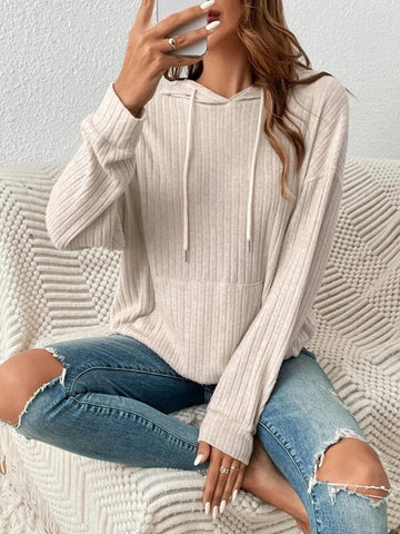 Model styling sage ribbed hoodie with ripped denim jeans – Voguelle