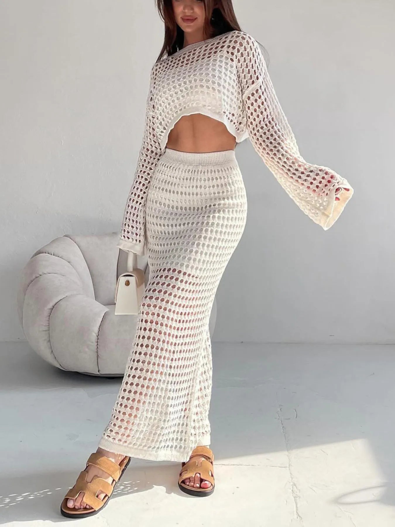 Front view of hollow out knit crop top with matching maxi skirt in white – Voguelle