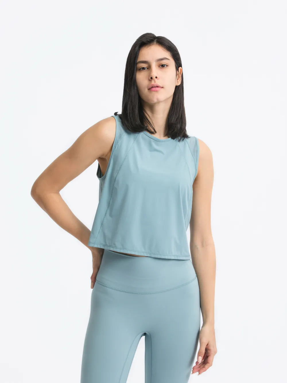 Model posing in Millennia Cropped Active Tank in blue – Voguelle