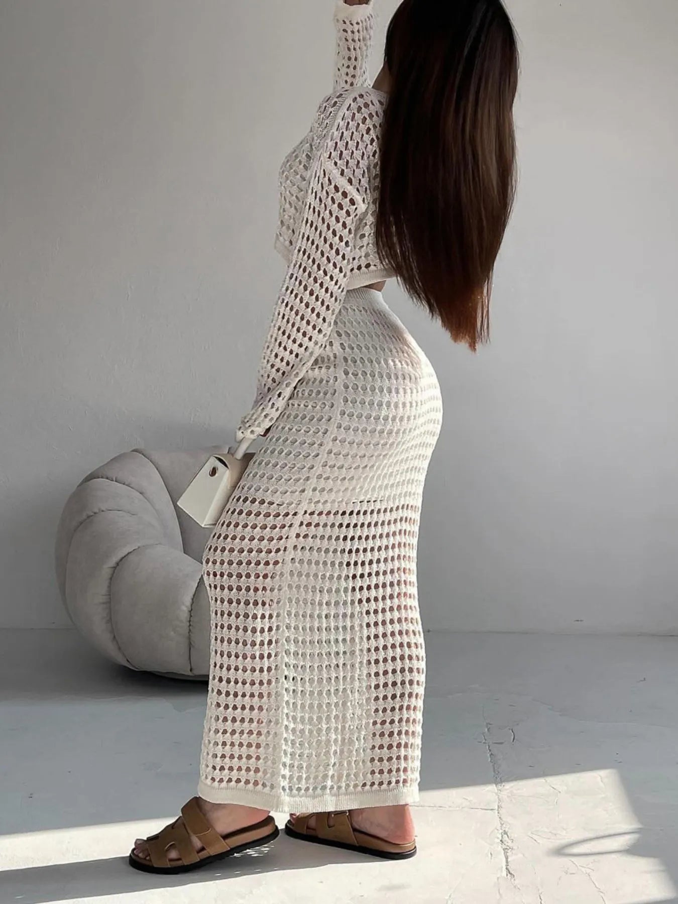 Model wearing hollow out knit maxi skirt with crop top in white – Voguelle