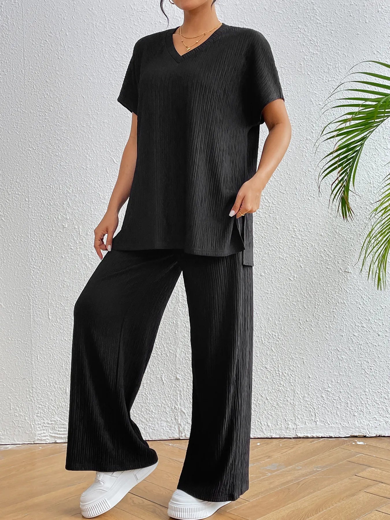 Styled look of black ribbed two-piece lounge outfit on model – Voguelle