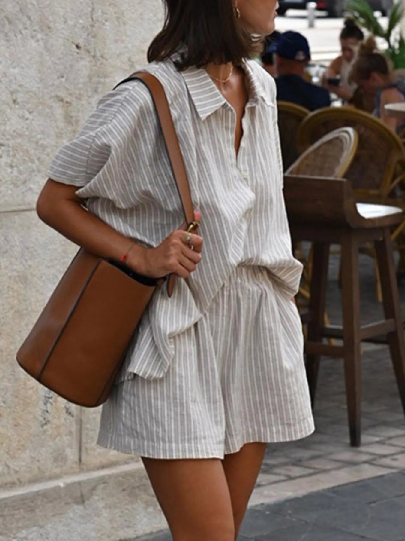 Close-up of striped button-up short sleeve top with collar – Voguelle