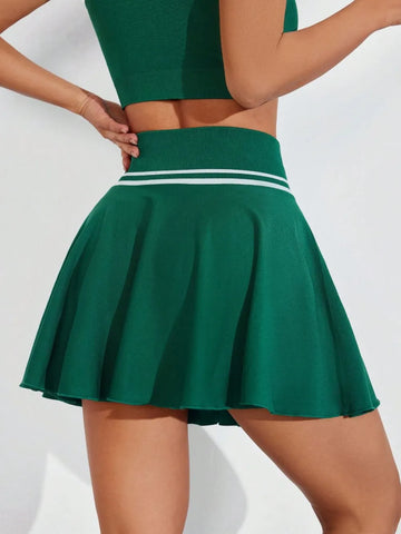 Model wearing green ruched high waist mini active skirt styled for active lifestyle – Voguelle