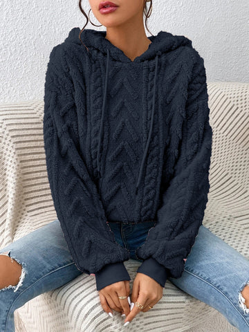 Model in beige fleece hoodie with soft textured fabric – Voguelle