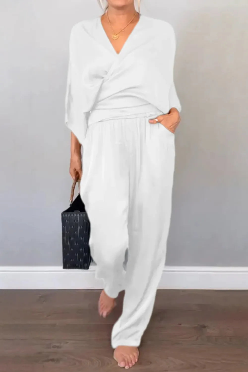 Black surplice jumpsuit with cropped sleeves and elastic waist – Voguelle