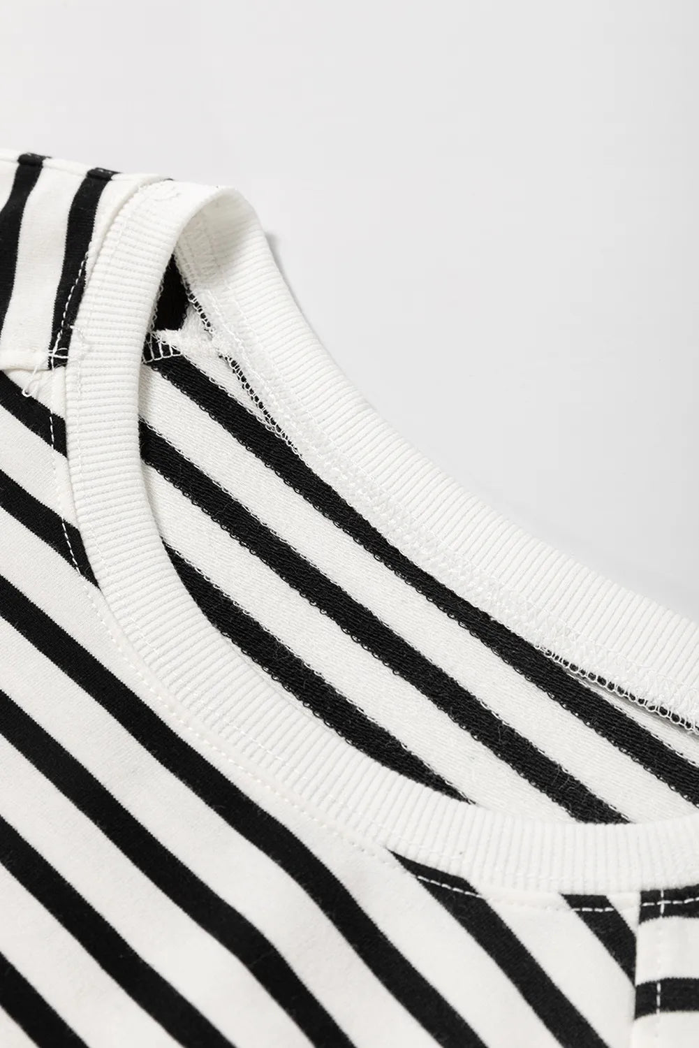 Model wearing striped round neck sweatshirt with side slit – Voguelle