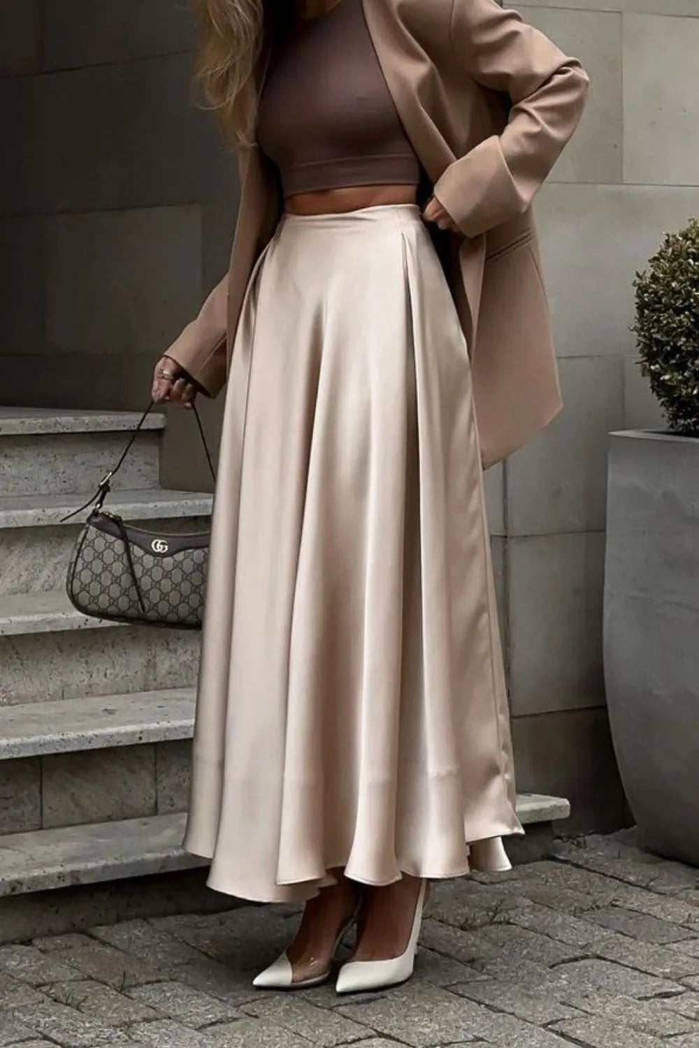 Side view of champagne satin midi skirt styled with blazer and white heels – Voguelle