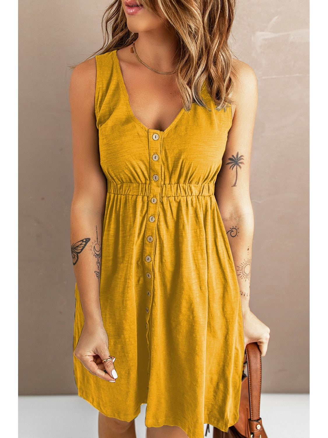 Back view of black sleeveless mini dress with button detail – Voguelle