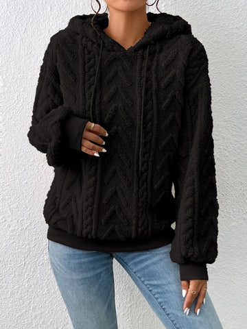 Model’s hand detail wearing beige fleece hoodie – Voguelle