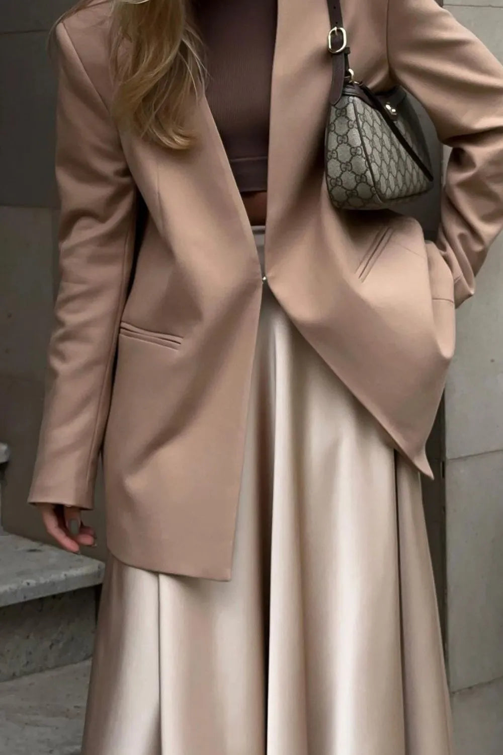 Model sitting in champagne satin midi skirt and blazer, elegant outfit – Voguelle