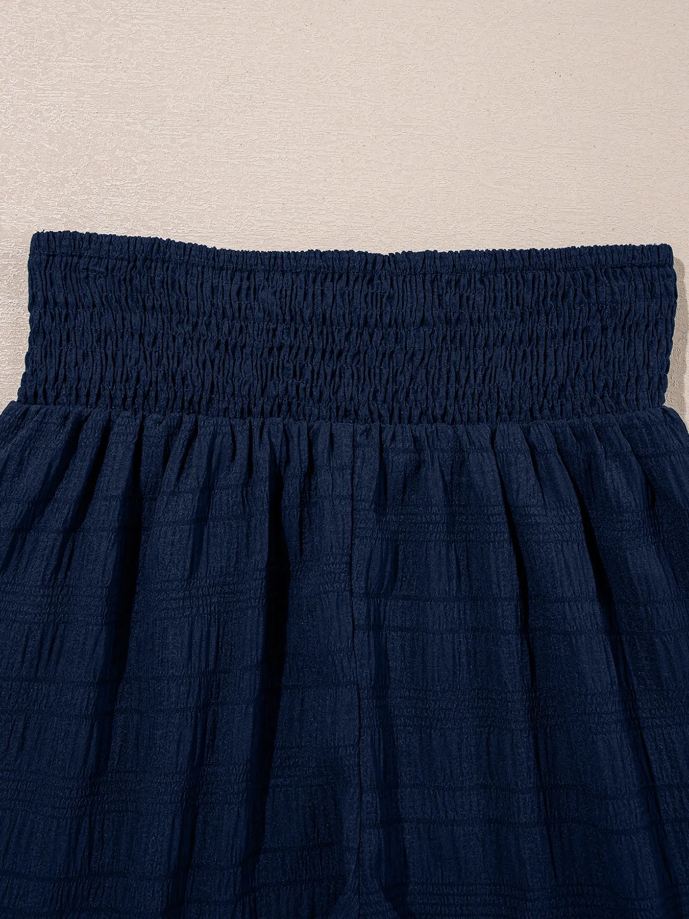 Flat lay of navy textured two-piece set with crop top and shorts – Voguelle