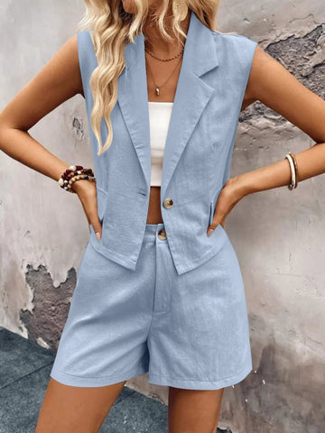 Close-up of zipper and button detail on blue sleeveless top – Voguelle