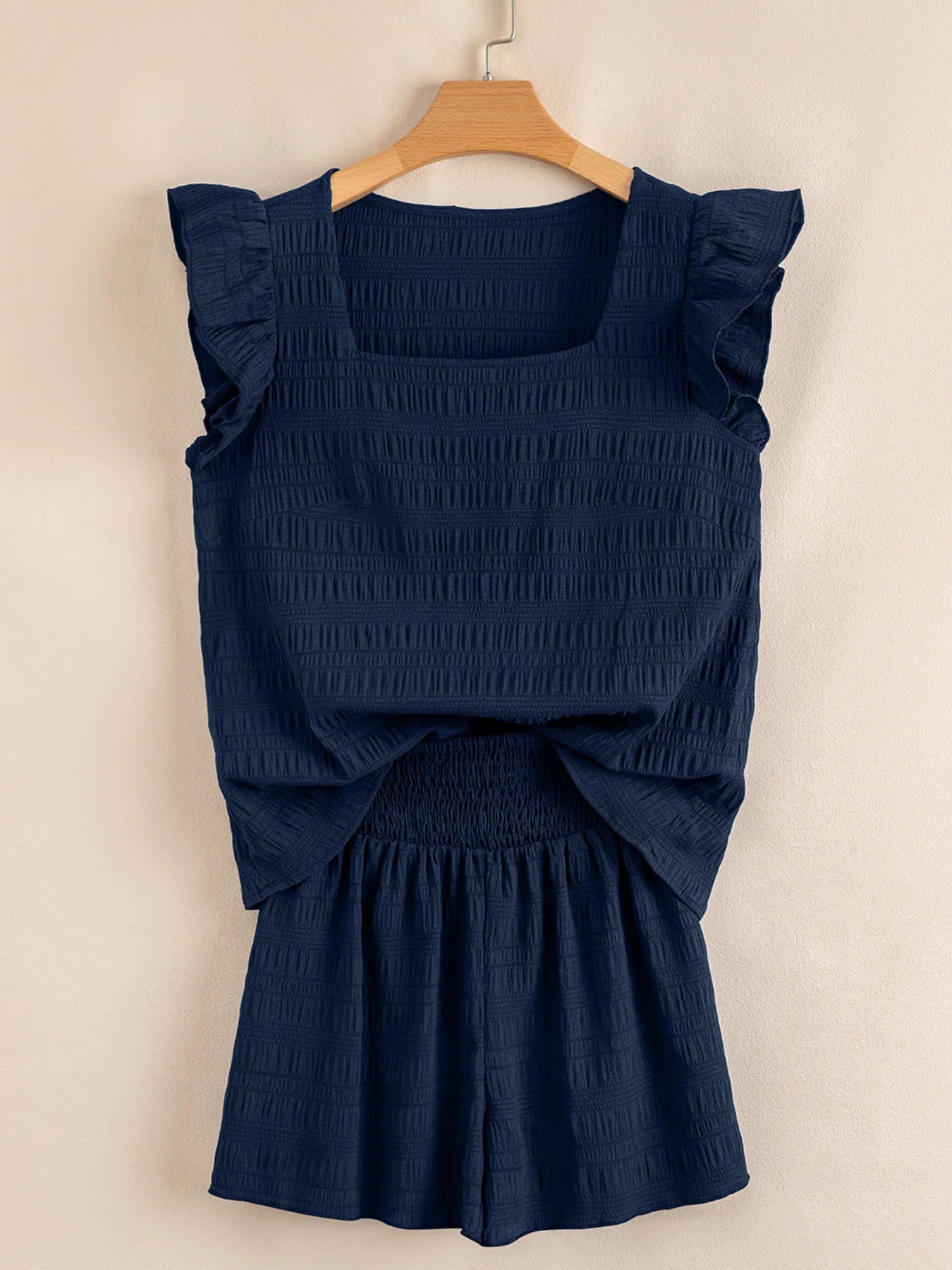 Close-up of square neckline and ruffle sleeve detail on navy crop top – Voguelle