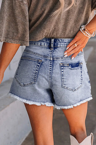 Close-up of pearl embellishment on denim shorts – Voguelle